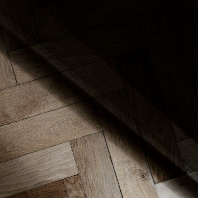 a wooden floor with a light shining on it